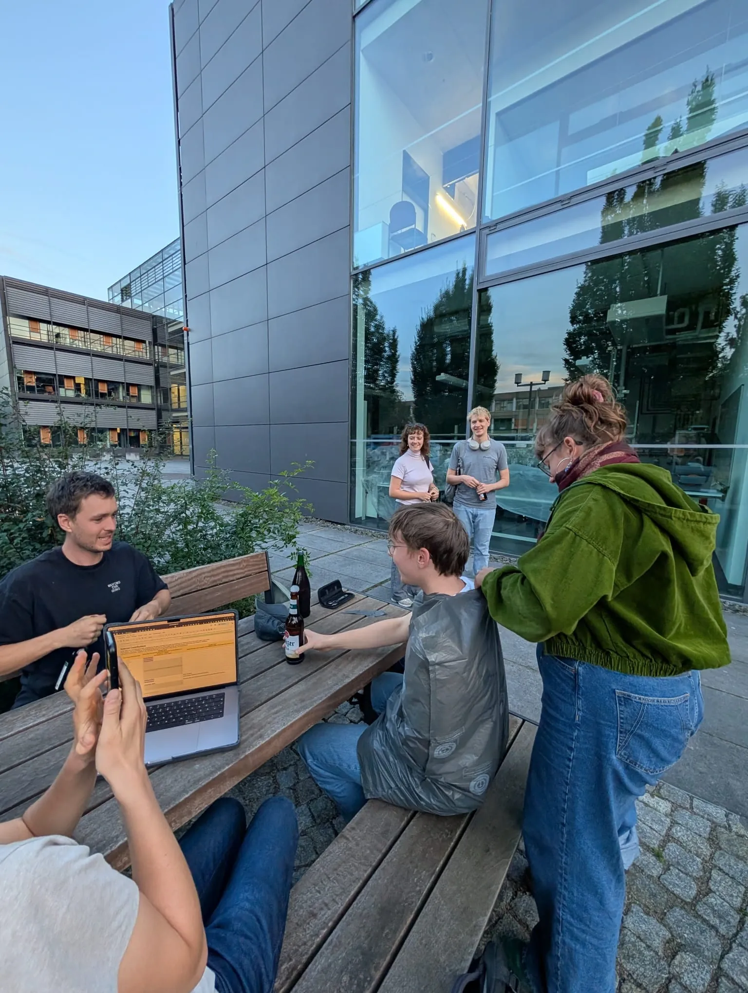 One of our teammembers is cutting the hair of another teammember.