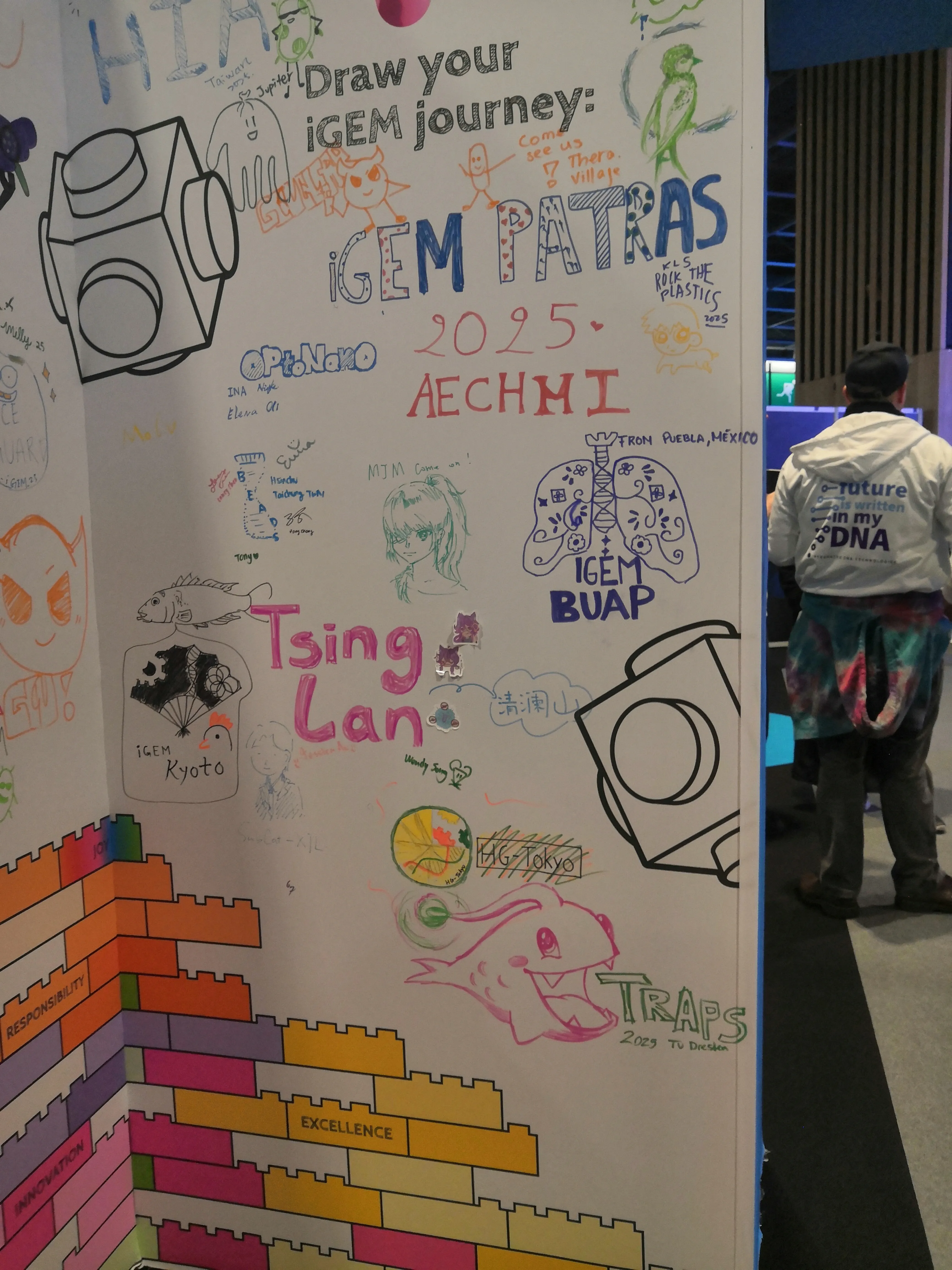 Our anglerfish mascot being drawn on a wall alongside other teams' drawings