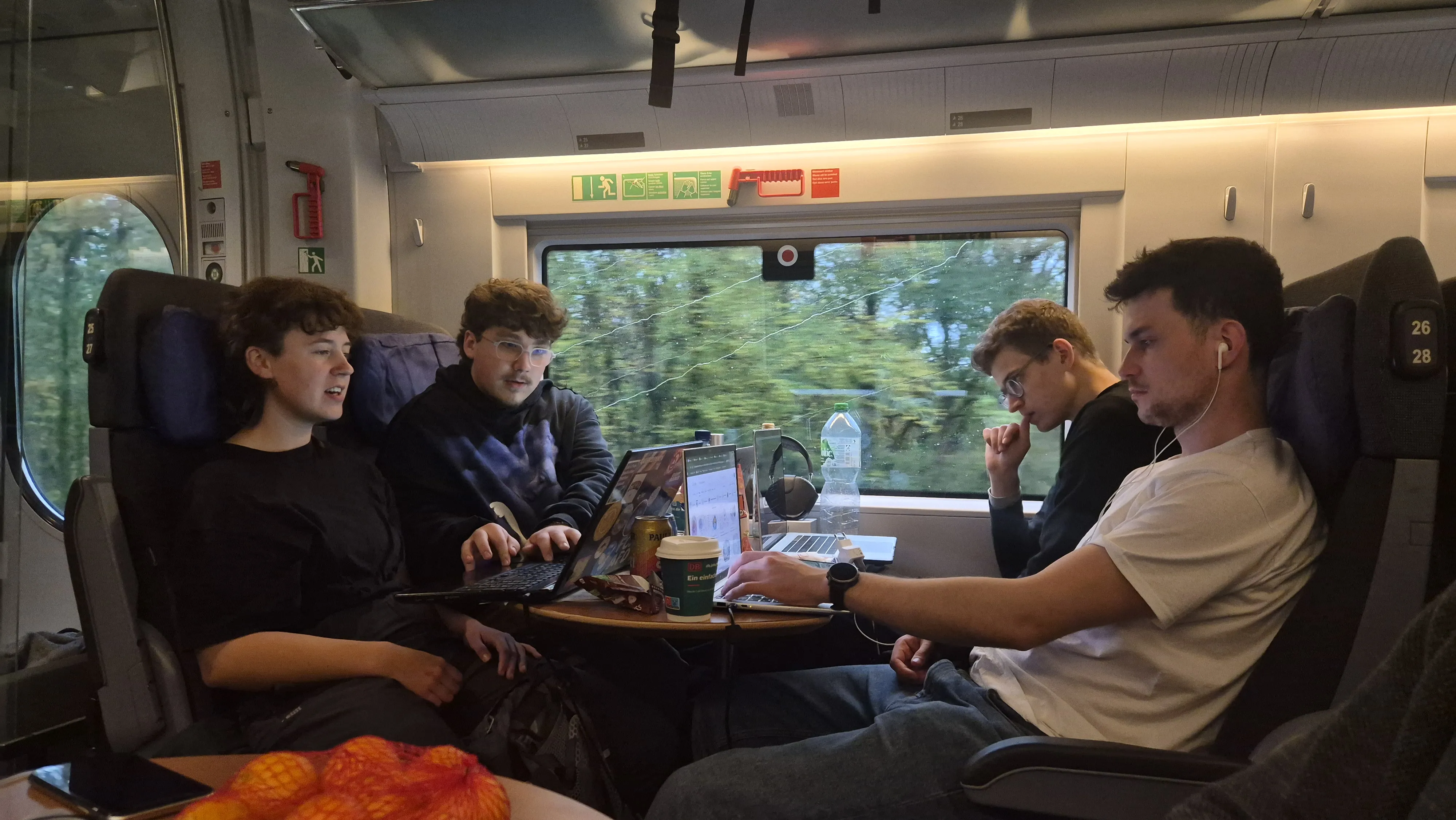 TRAPS members working on their laptops in a train.