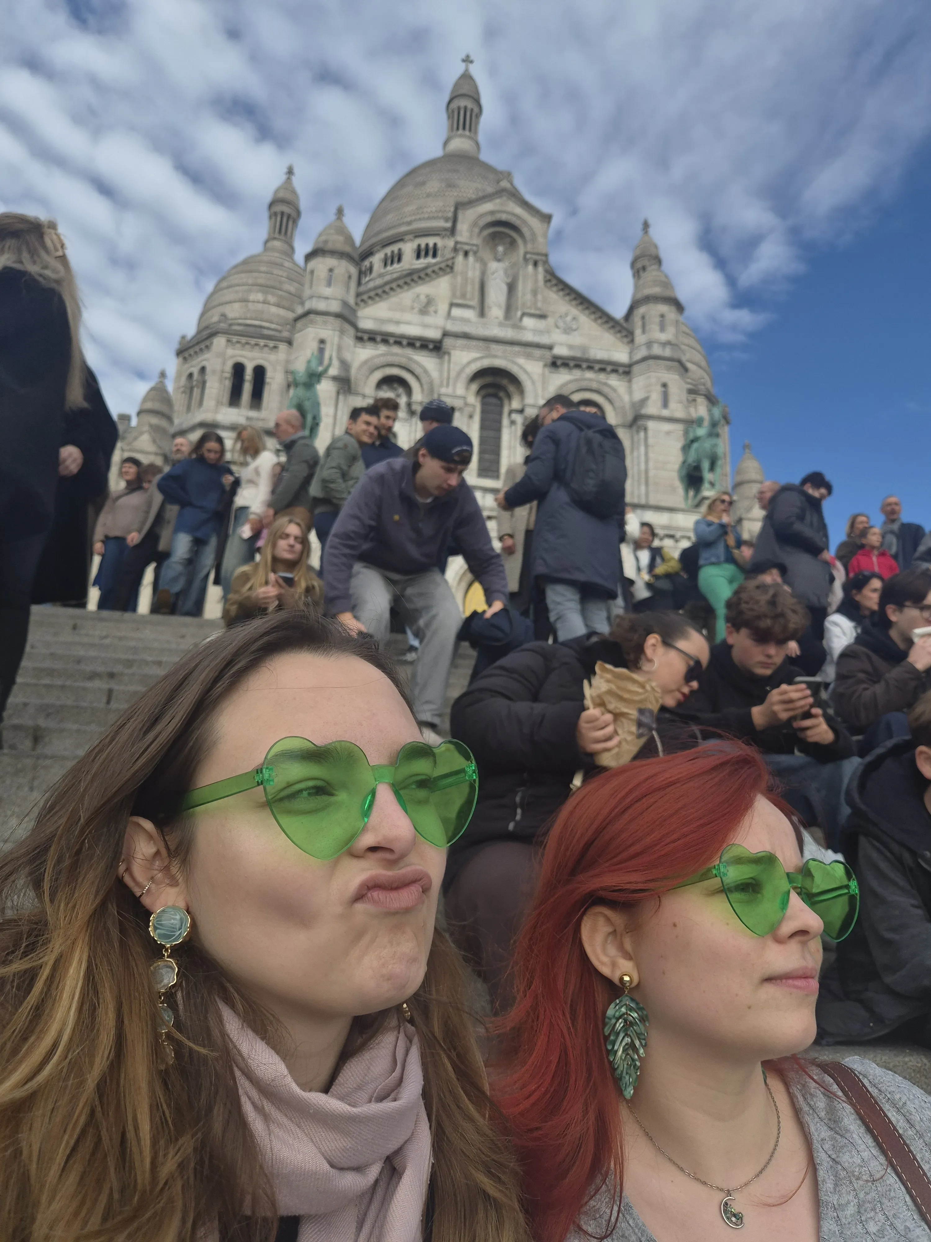 TRAPS members wearing green heart-shaped glasses in front of Sacre Coeur.