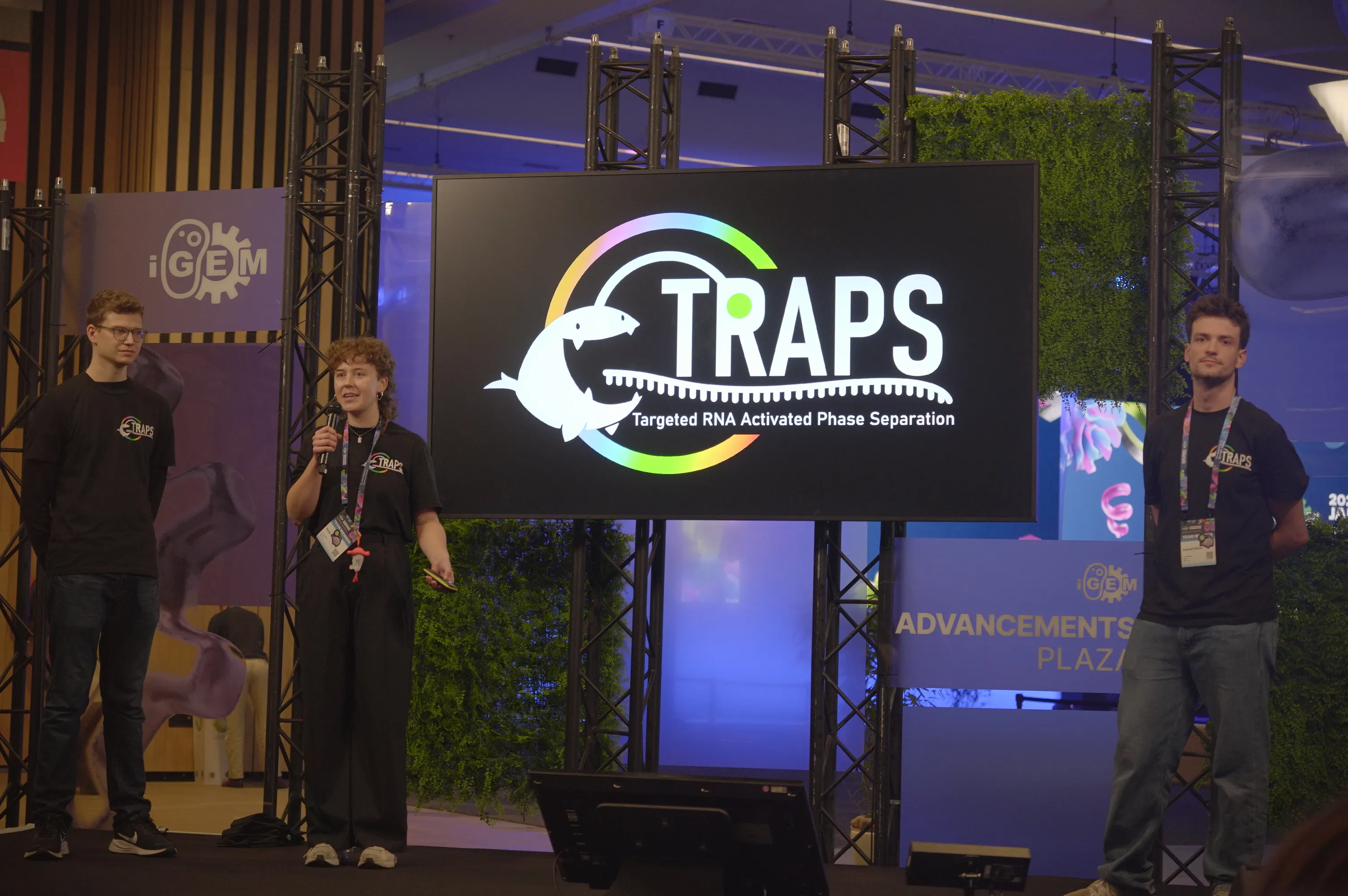 TRAPS members on a small stage presenting their project.