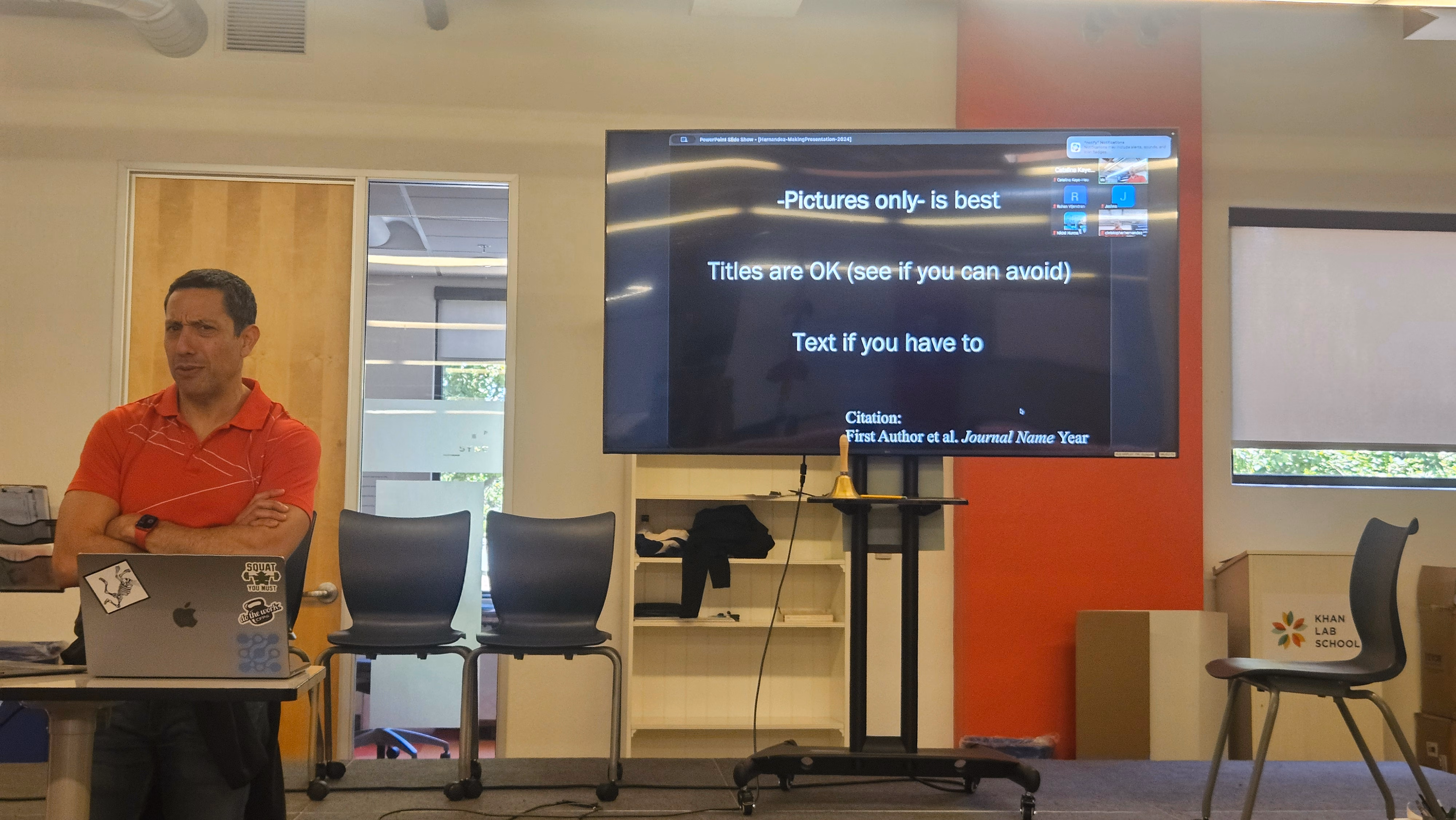 Christopher Hernandez standing in front of a TV showing information on slideshow formatting.