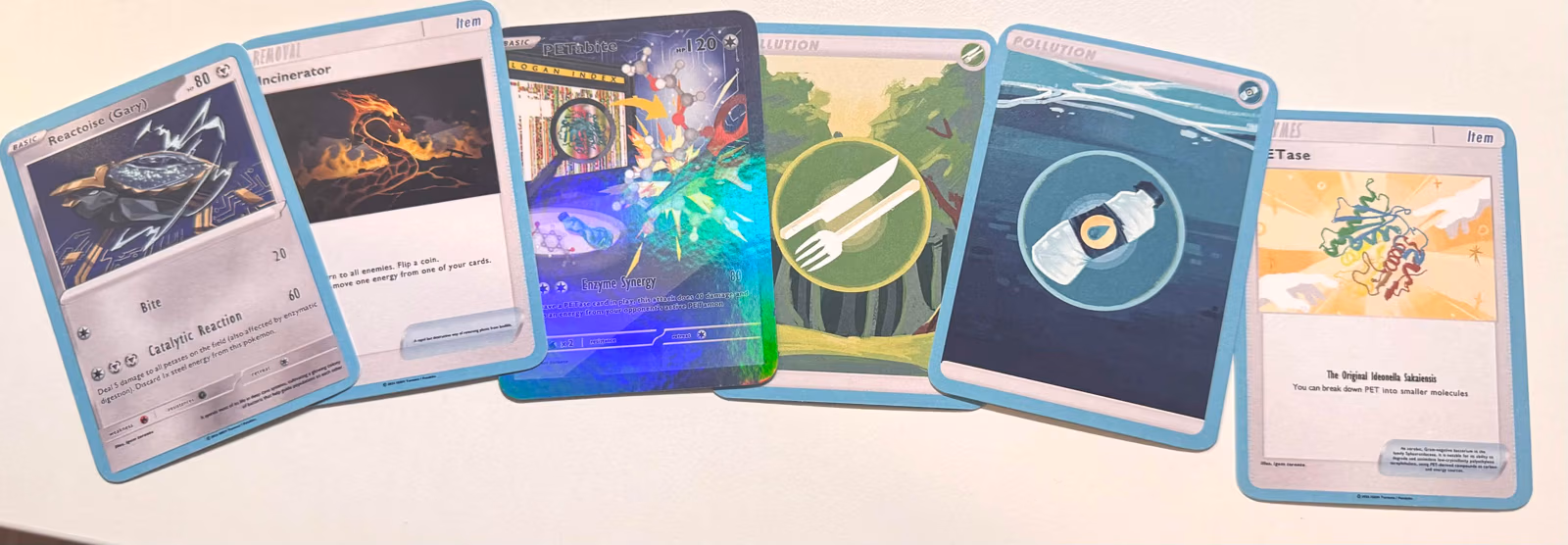 A fanned-out row of printed PETamon trading cards