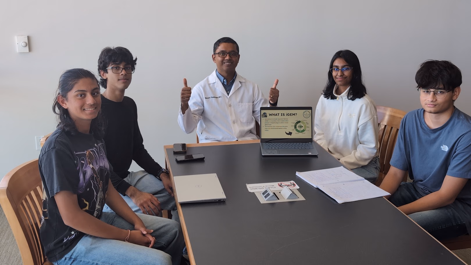 Dr. Puchakayala standing with the student team at the end of the session.