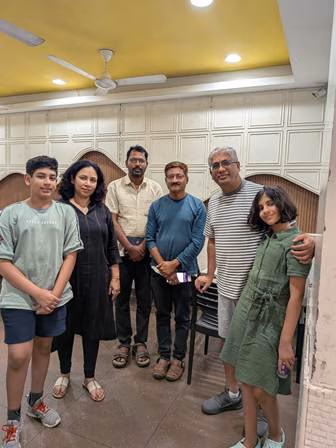 Seven people standing together indoors, the team's PI and lab mentor among them, during the visit to the Center for Sustainable Agriculture in India.
